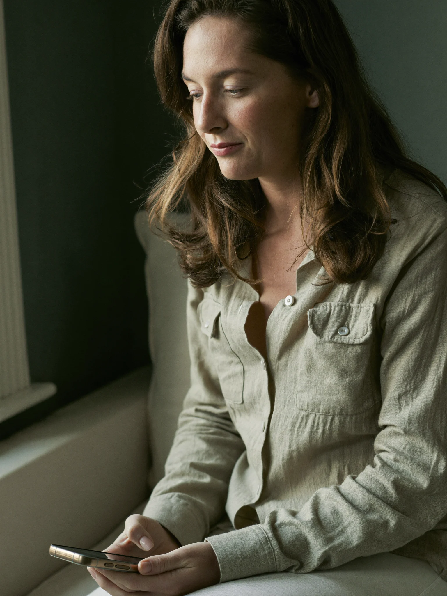 A woman checking her phone during a quiet moment at home